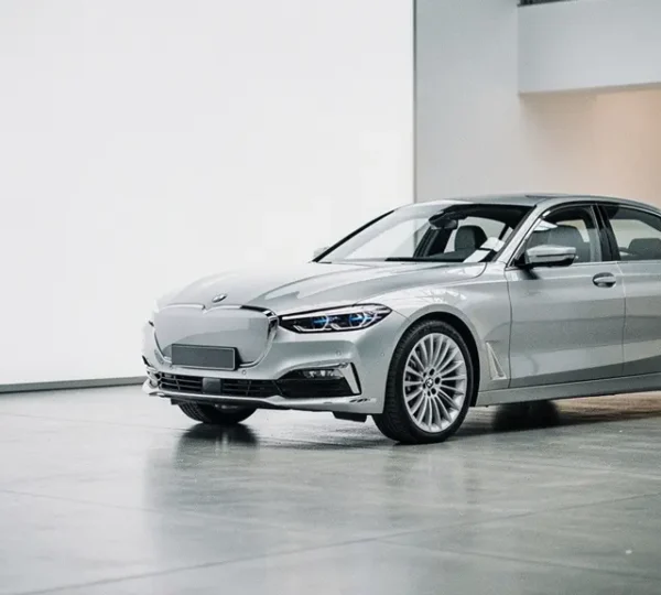 Premium car in neutral metallic finish displayed in elegant showroom lighting