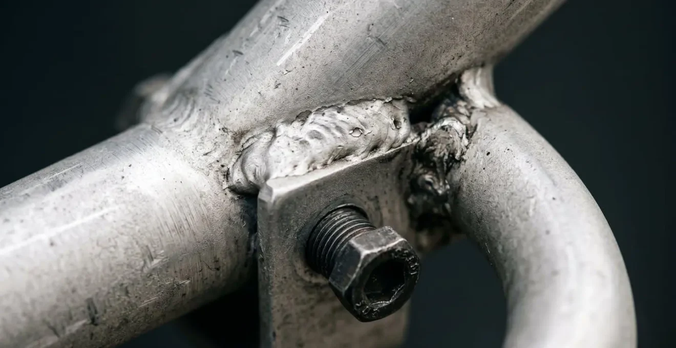 Macro detail of bike rack mounting hardware under stress showing material fatigue